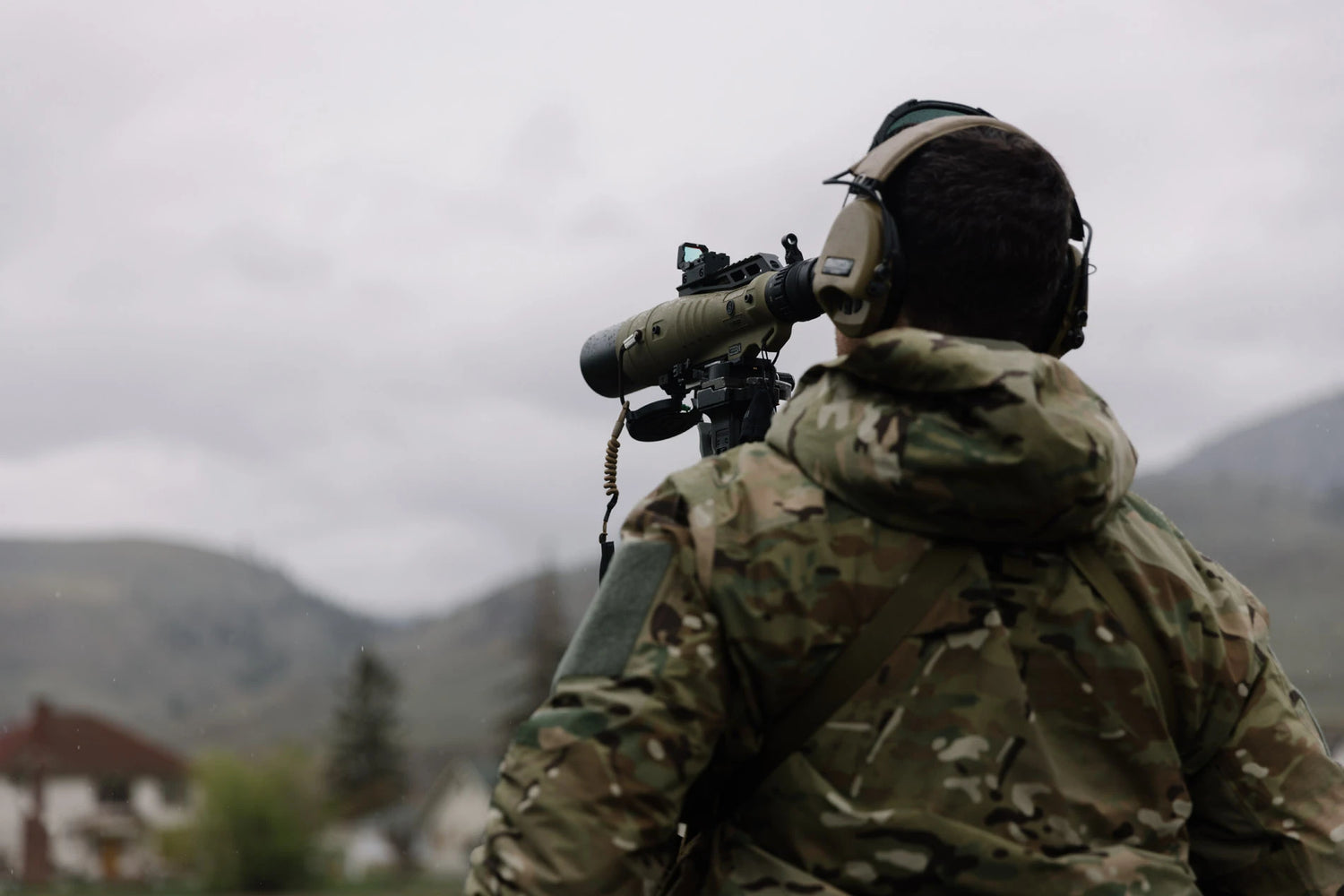 Cold Weather Protection: Man wearing Tomahawk Performance Cold Weather Insulated Jacket looking through scope