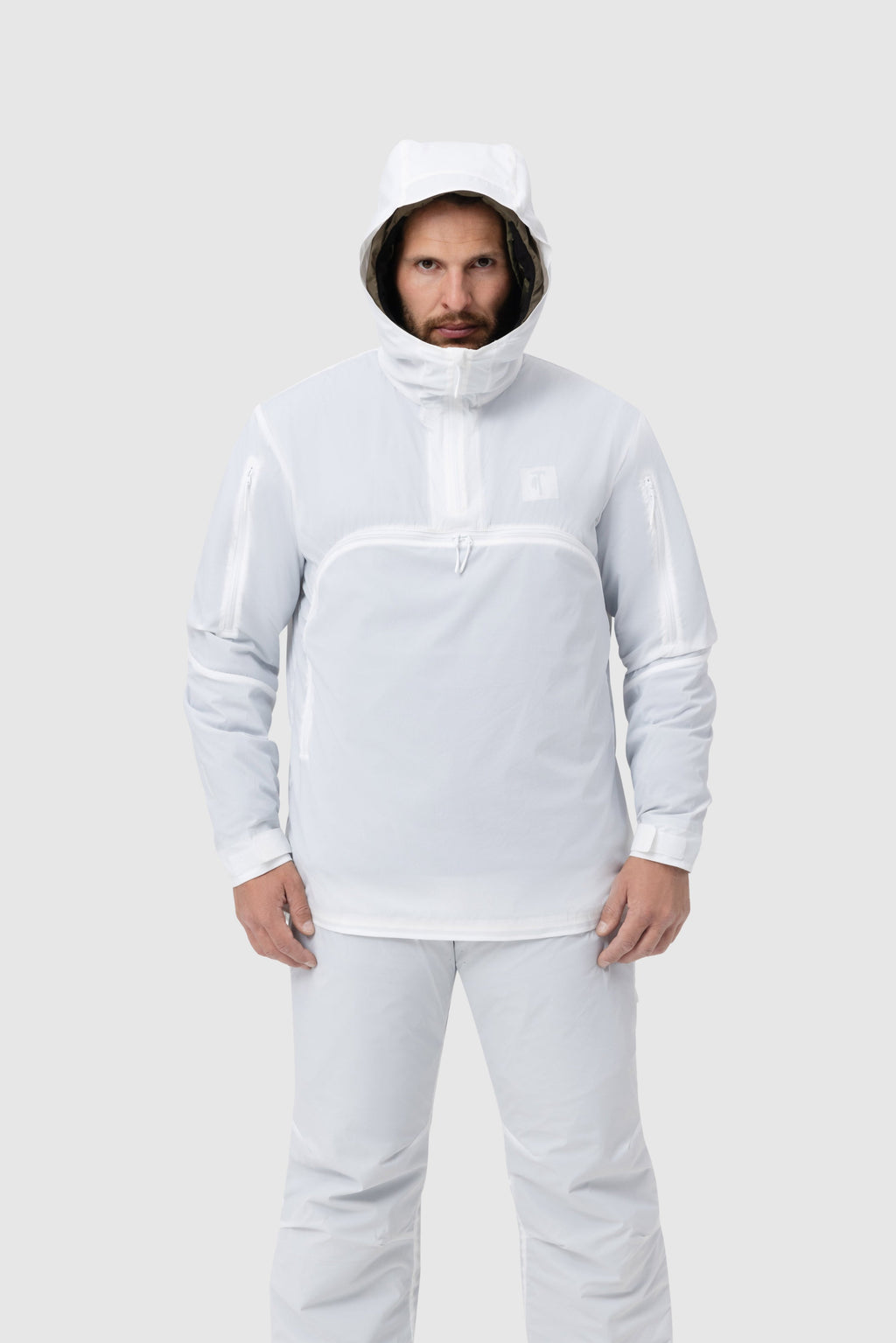 Frontal photo of the Tomahawk Performance Overlayer Anorak, tactical alpine overwhites, in the Overwhite color way, with the hood up.