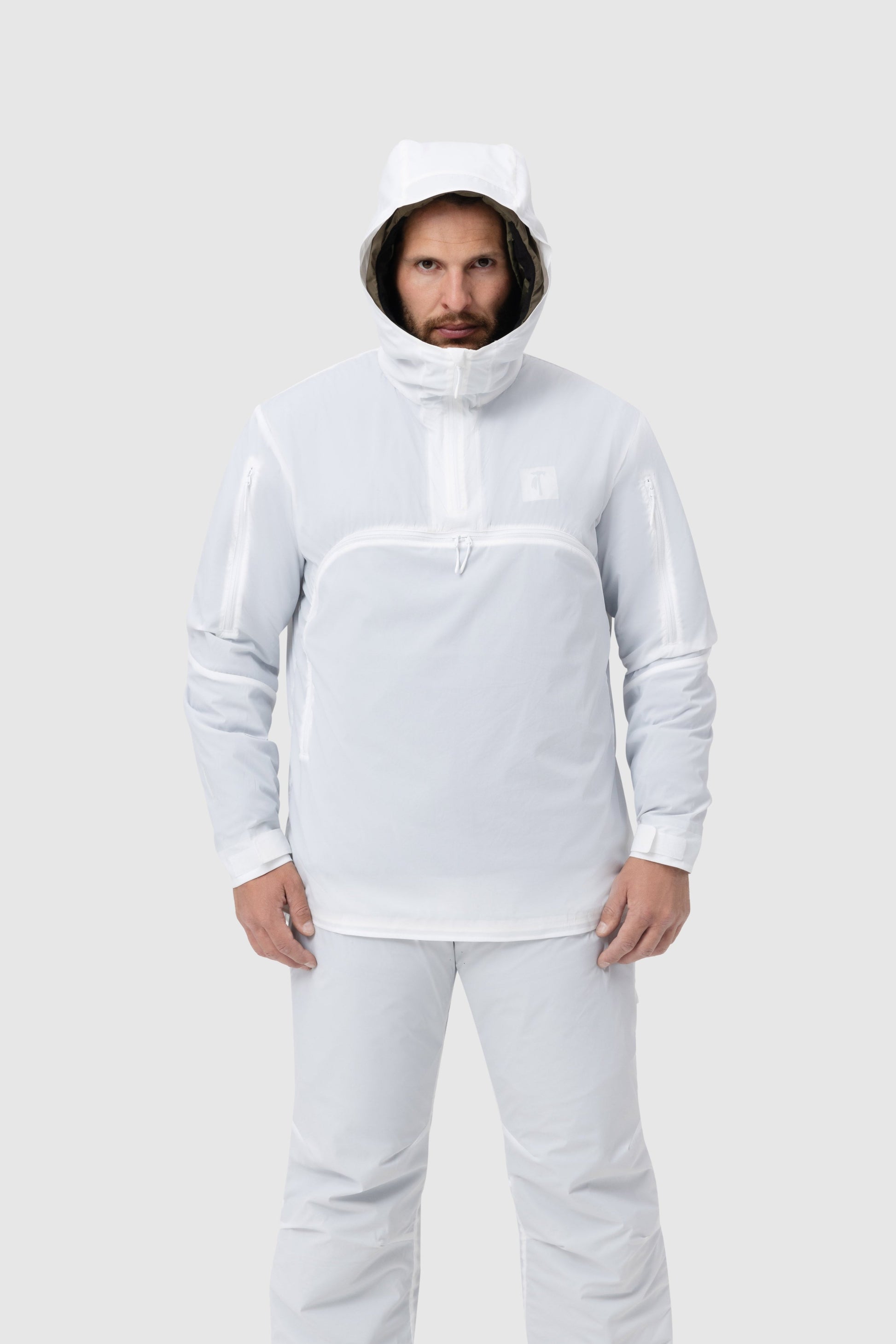 Frontal photo of the Tomahawk Performance Overlayer Anorak, tactical alpine overwhites, in the Overwhite color way, with the hood up.