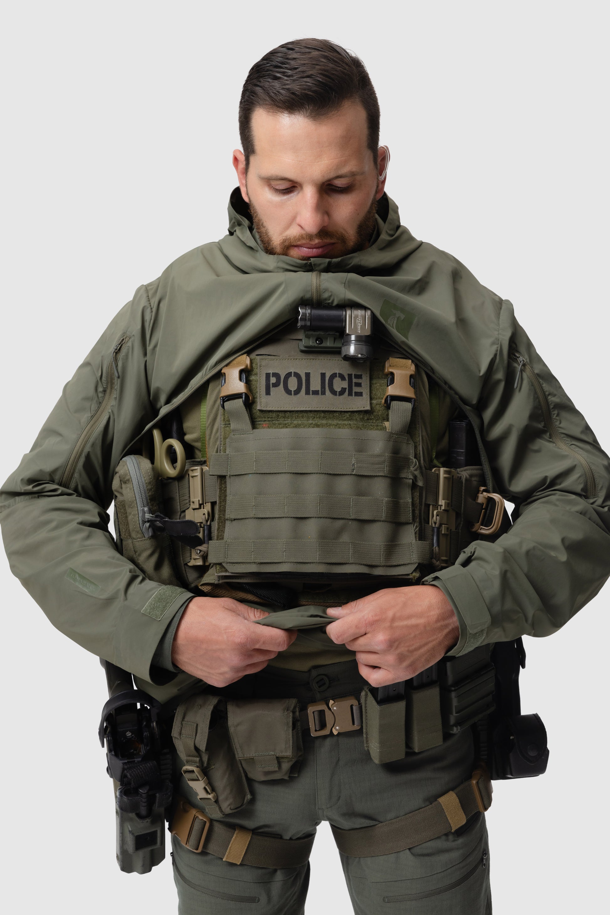 Frontal photo of the Tomahawk Performance Overlayer Anorak, tactical urban or military use weather protective layer, in the Ranger Green color way. Reverse-U zip is shown open to access a carrier.
