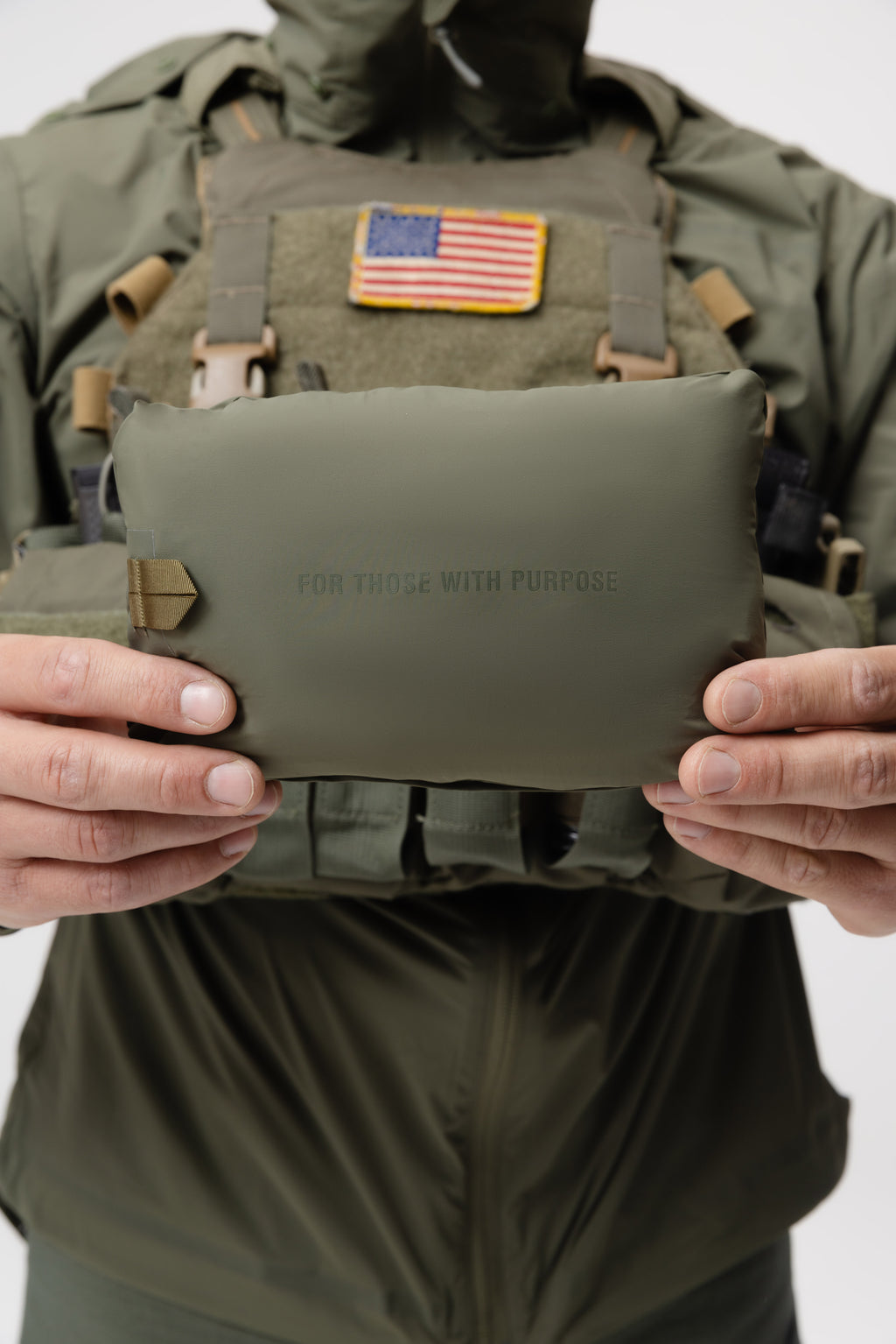 Photo of the Tomahawk Performance Crosswind Jacket, a tactical windbreaker, packed into its own integrated stow pouch in Ranger Green color way.