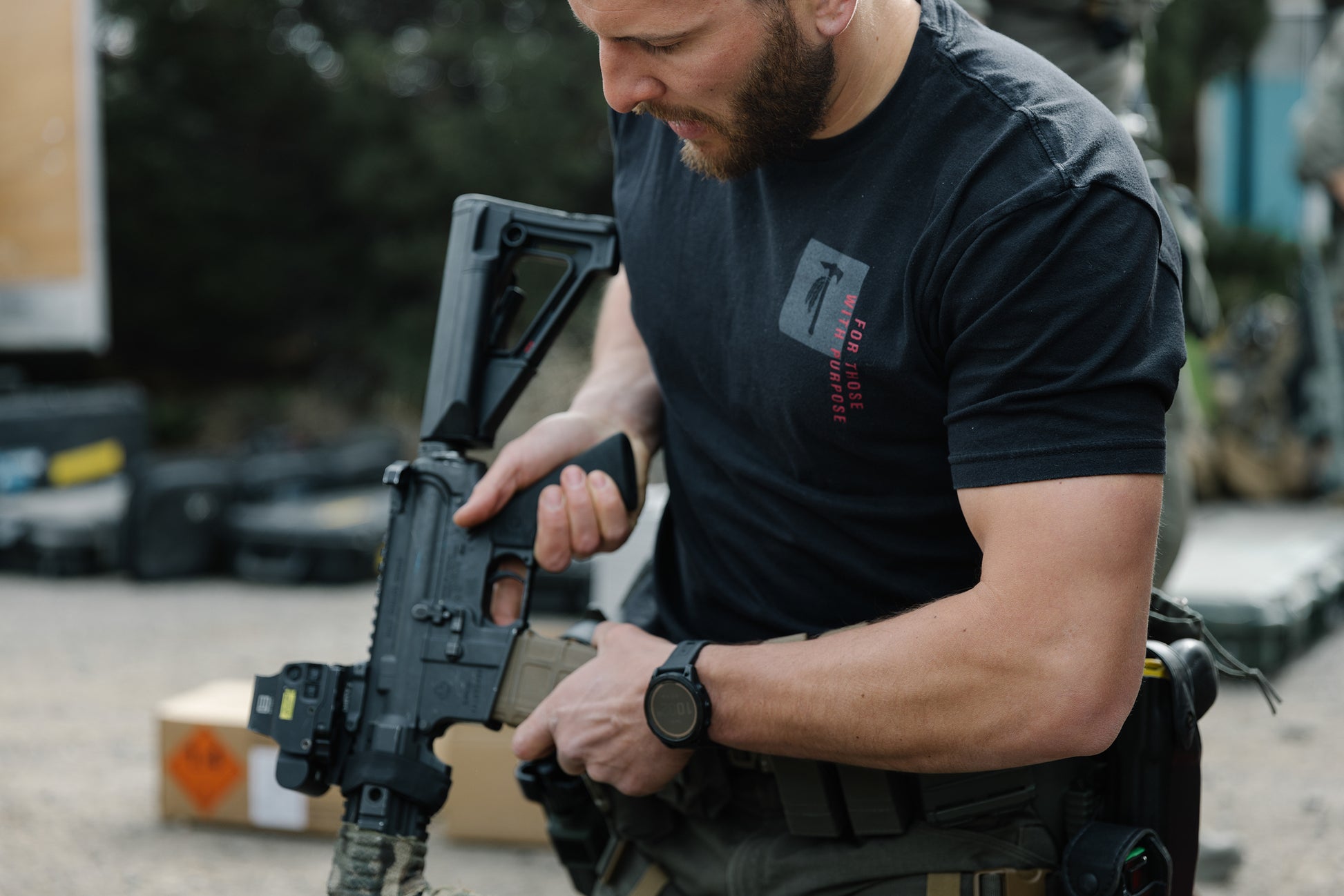 Photo of a man wearing the Tomahawk Performance FTWP T-Shirt SS handling a gun.